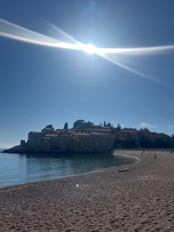 Tourists enjoy spring day at Montenegro's Sveti Stefan beach