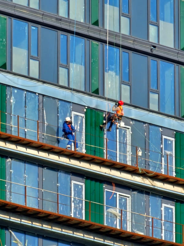 Workers rappel down building facade in Khimki, Russia