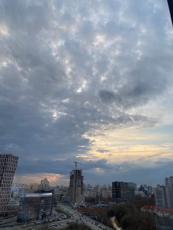 Window cleaner works on Yekaterinburg high-rise amid construction activity