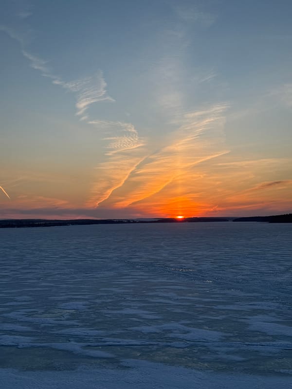 Sunset observed over frozen reservoir in Votkinsk Russia