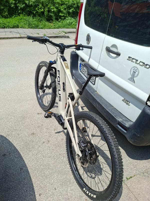 Mountain bike spotted against parked van in Gabrovo