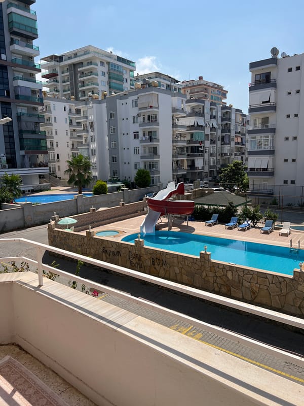 Sunny morning at an Alanya residential complex with blooming bougainvillea