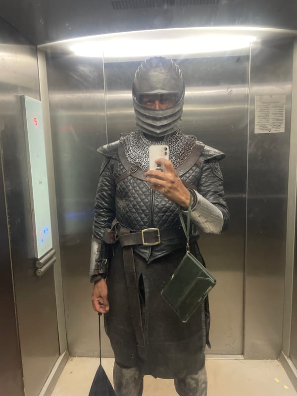 Medieval armored figure takes elevator selfie with smartphone