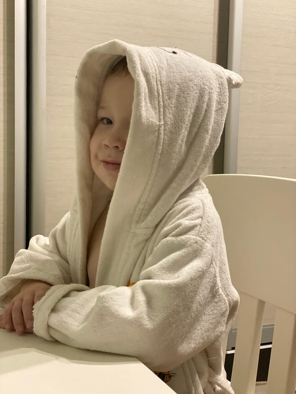 Child in white bathrobe spotted indoors in Sochi