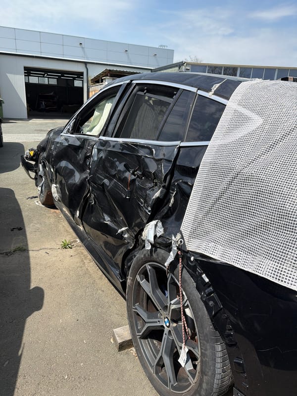Damaged BMW and Toyota Supra documented at automotive workshop