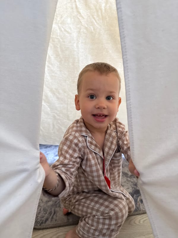 Toddler in pajamas playing indoors in Rusanovo, Russia