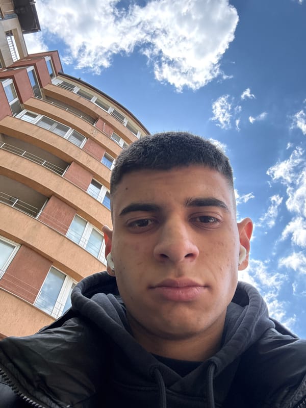 Young man takes selfie in Sofia wearing hoodie and earbuds