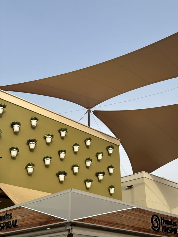 Afternoon at a Spanish open-air mall with shops, plants, and snacks