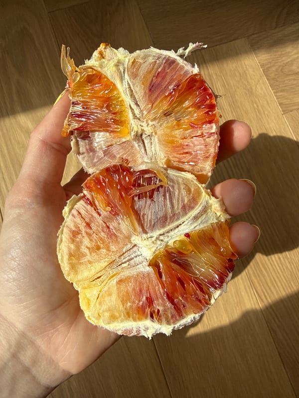 Moscow resident peels blood orange Thursday morning