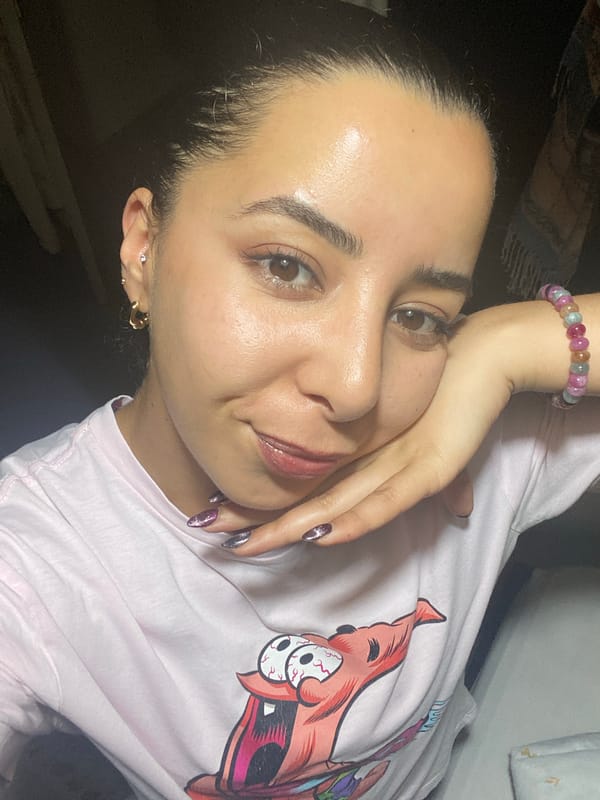 Woman in pink cartoon shirt photographed lying down