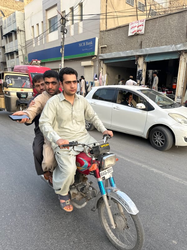 Three men share motorcycle ride in Quetta City