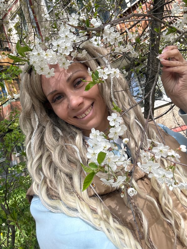 Woman rests among white flowers in Yaroslavl park
