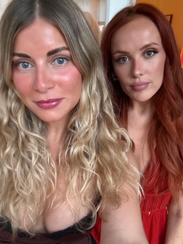 Two women take selfies together indoors in Paris