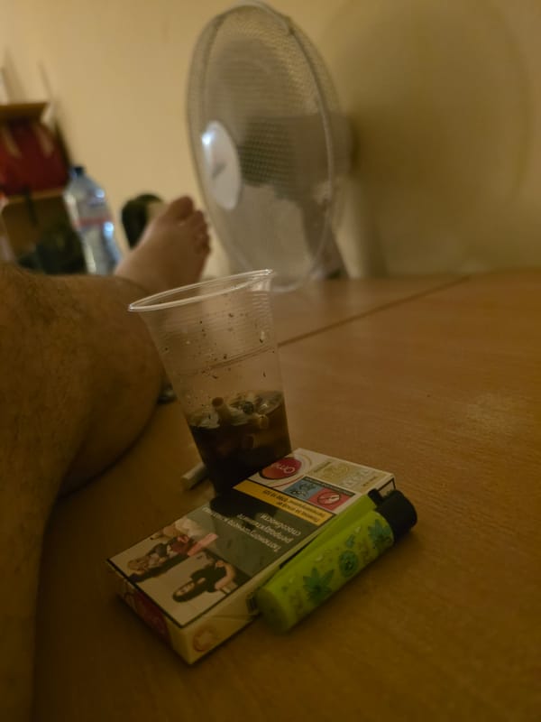 Quiet room scene in Veliko Tarnovo, cigarettes and bread on a wooden desk