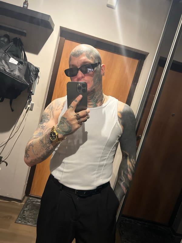 Tattooed individual takes mirror selfie in Kudrovo, Russia