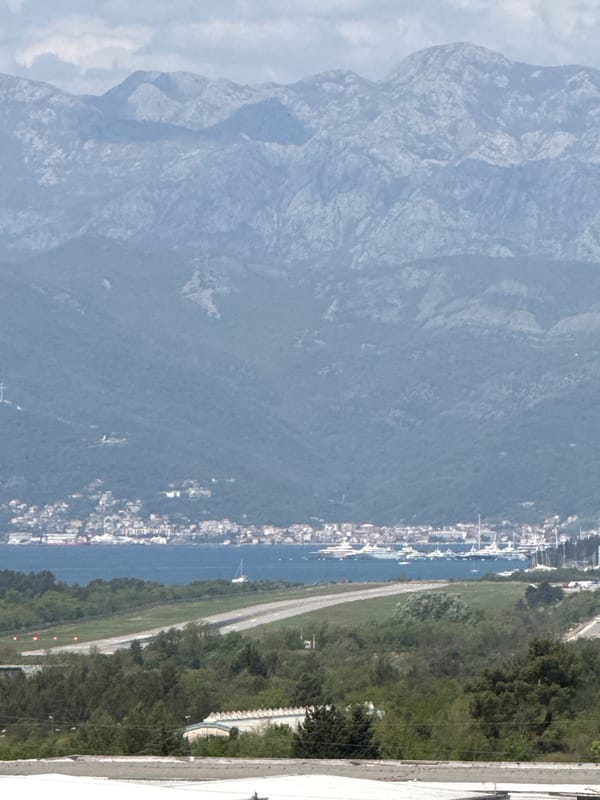 Aerial view captures coastal Sutvara, Montenegro with boats and mountains