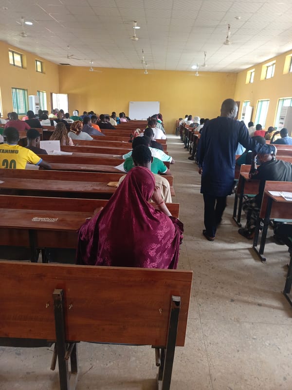 Students gather for exam or lecture in Akwanga classroom