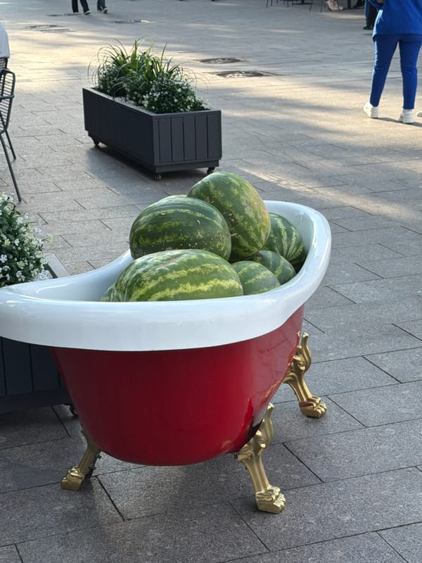 Red bathtub full of watermelons on a Moscow street.
