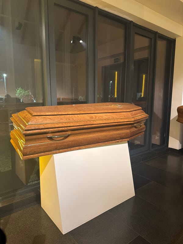Funeral home displays coffins and urns witnessed by observers