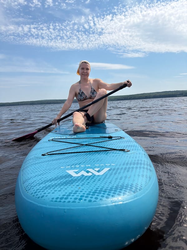 Stand-up paddleboarding on calm water near Chaikovsky, Russia