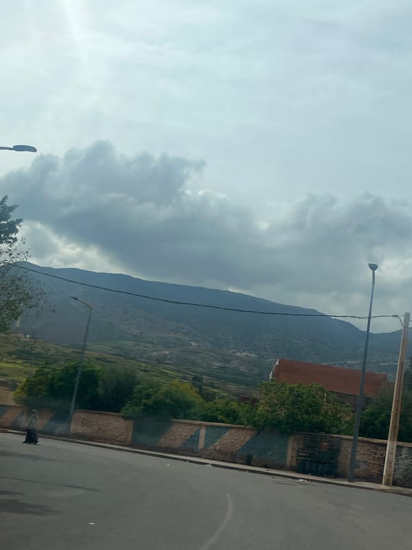 Driver documents street scenes during journey through Ouaouizert, Morocco