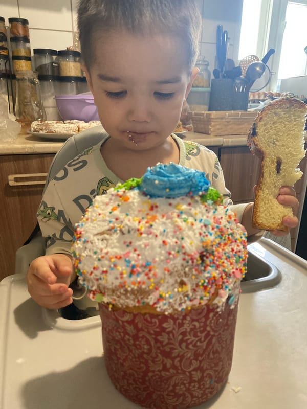 Child eating textured bread in high chair, Orenburg