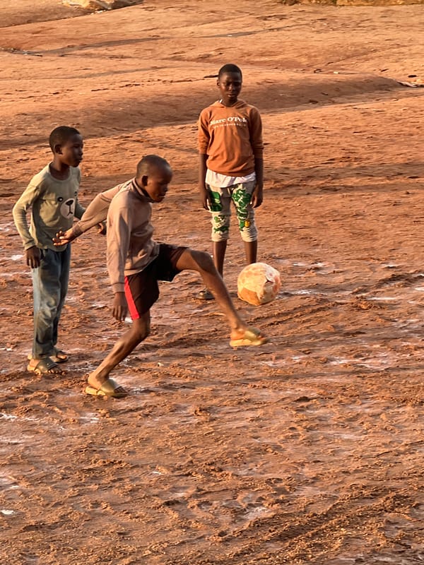 Pickup soccer and a hazy sunset in Jos, Nigeria
