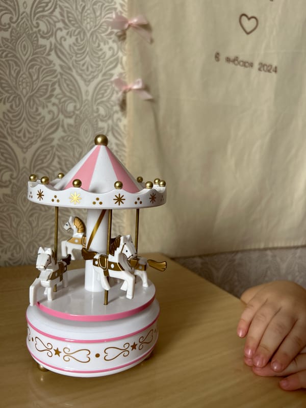 Child plays with carousel music box in Ufa
