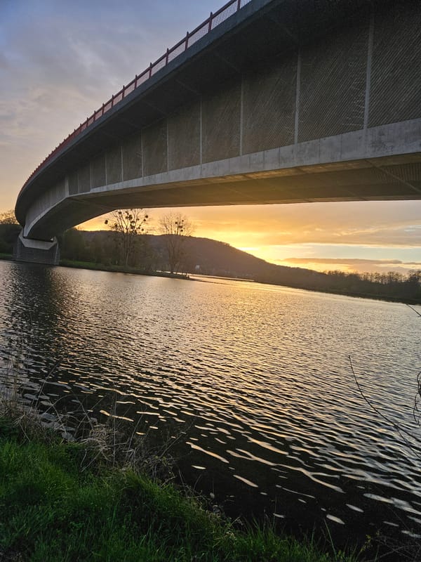Sunset captured over river bridge in Konz, Germany