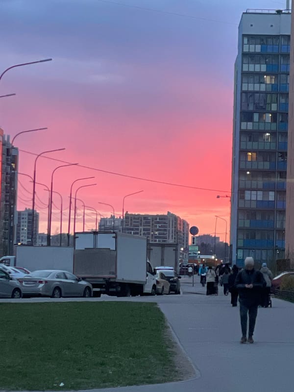 Vibrant sunset colors illuminate Murino, Russia street scene