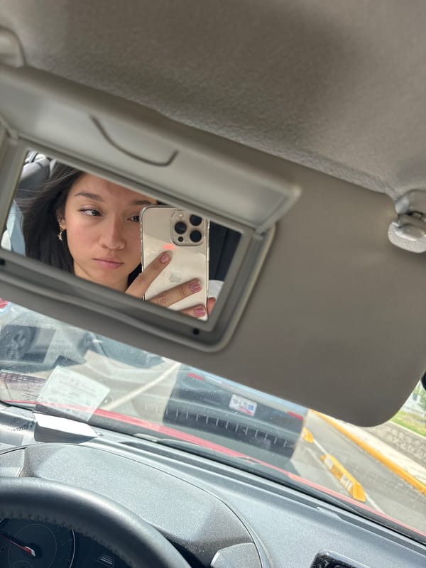 Woman takes selfie in car mirror, Puebla Mexico