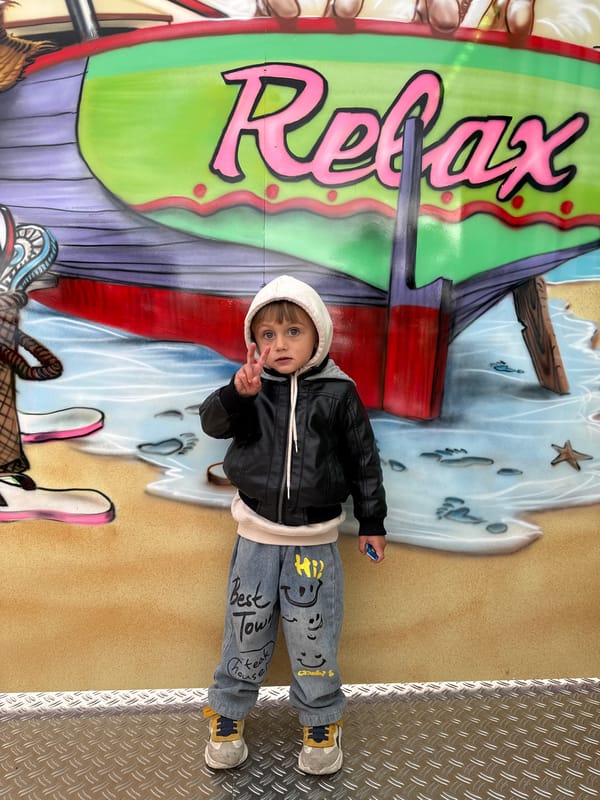 Child stands by 'Relax' boat mural in Riedlingen