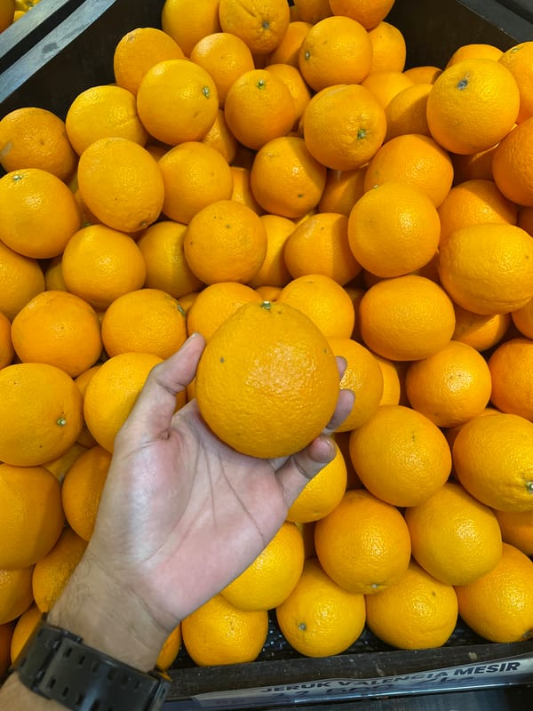 Shopper documents tropical fruit variety at Central Jakarta market