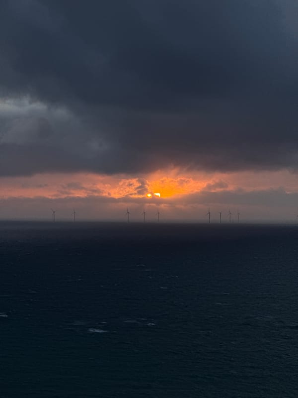 Sunset illuminates offshore wind farm near Fécamp, France