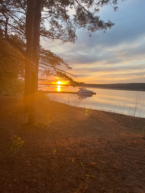 Sunset observed over lake with dock structure
