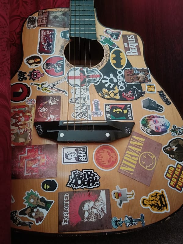 Vintage Soviet Olympic pins and a stickered guitar on display
