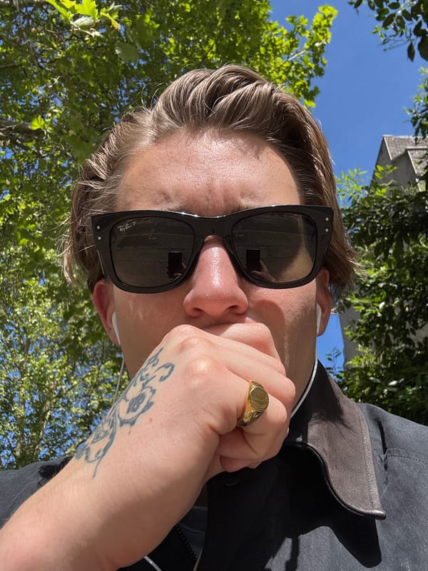 Person with coffee cup spotted on sunny London street