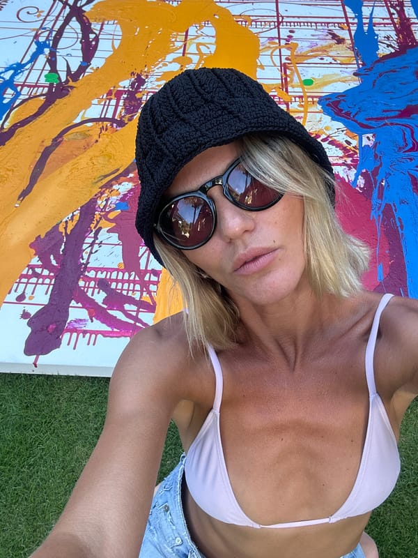 Woman poses with abstract art display on North Kuta lawn