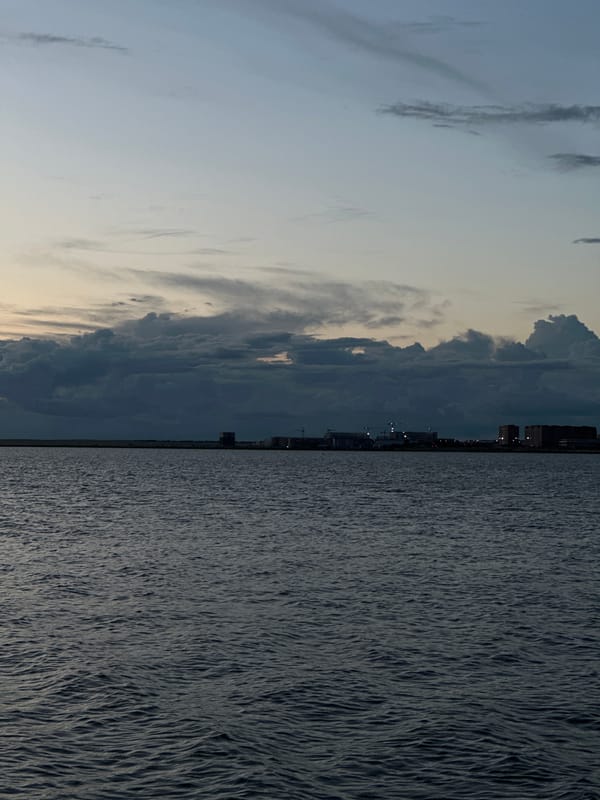 Dusk over Kokshetau — water, clouds, and a construction site