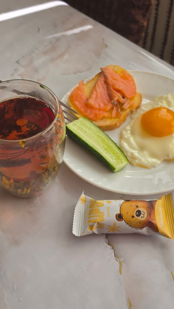 Morning breakfast preparation with decorative coffee and Siamese cat