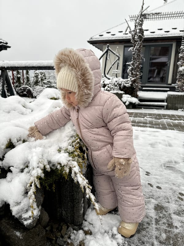 Toddler plays in fresh snow outside Wisła home