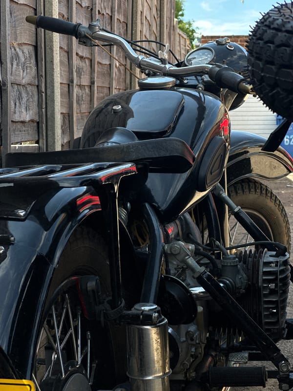 Vintage motorcycle with sidecar parked up, details explored