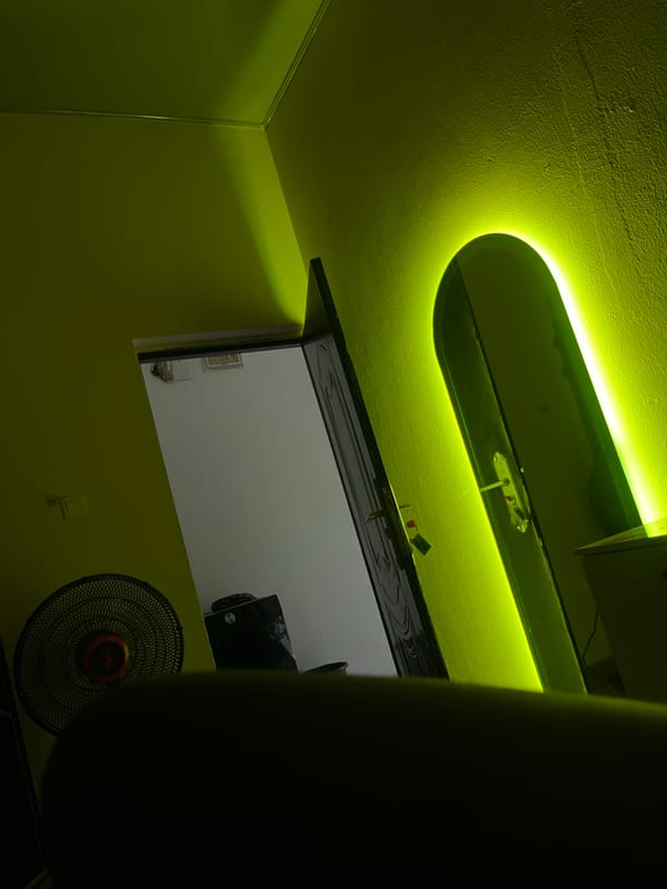 Lime-green room with neon ceiling fixture captured indoors