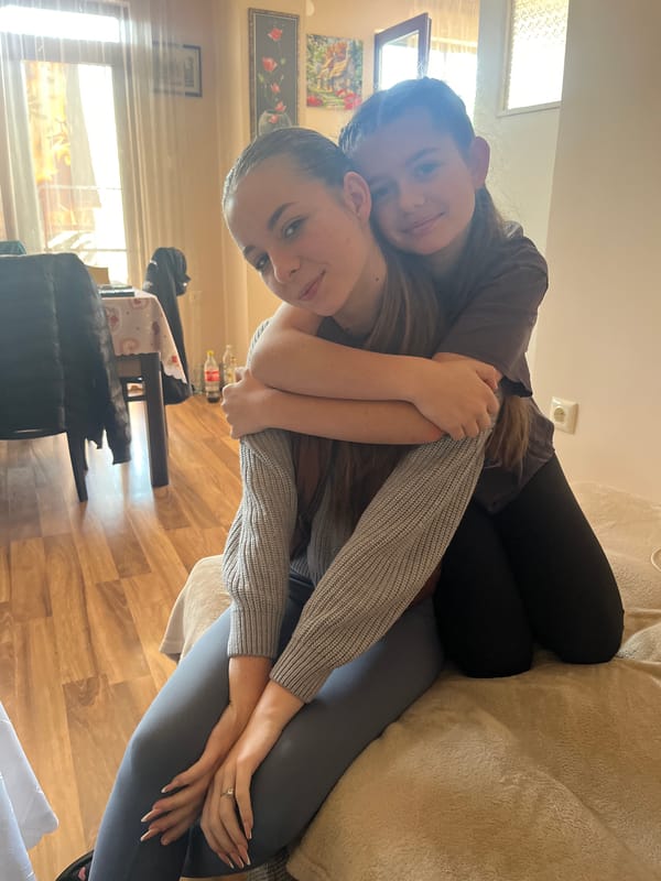 Two women share quiet moment on couch in Nova Zagora