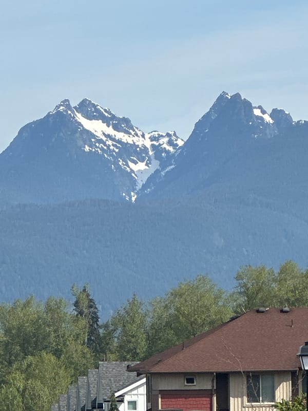 Clear skies frame snow-capped Coast Mountains in Maple Ridge
