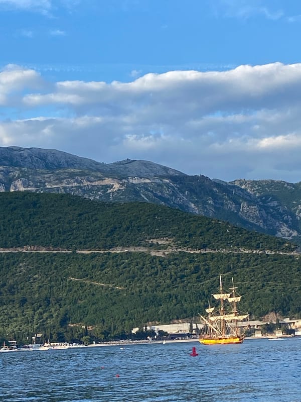 Coastal scene with sailing ship and contrails observed