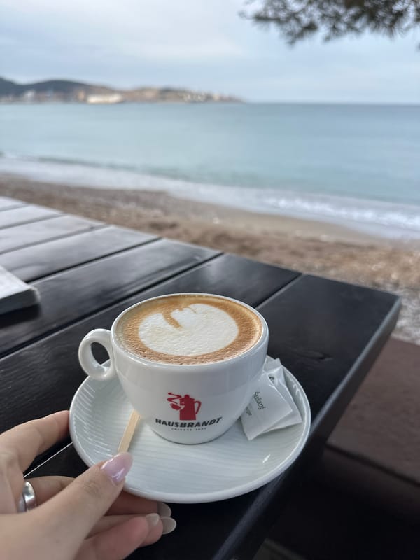 Morning cappuccino enjoyed at beachside cafe in Šušanj, Montenegro
