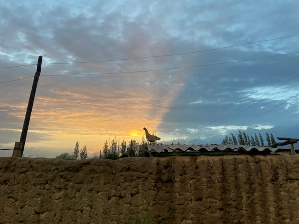 Rainbows and golden light over a rural Kyrgyz village