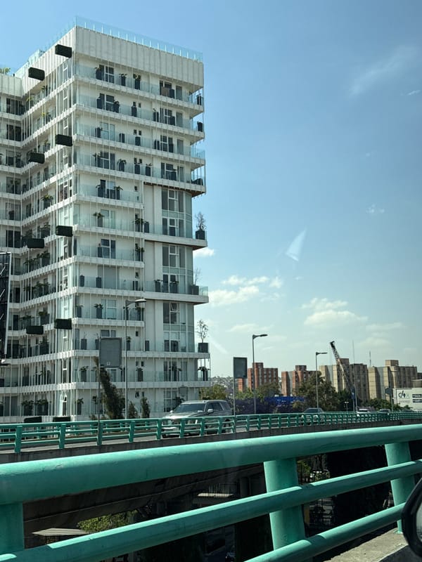 Vehicle travels elevated highway in Mexico City showing urban skyline