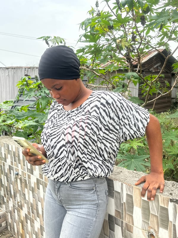 Woman documented using smartphone outdoors in Badagry, Nigeria